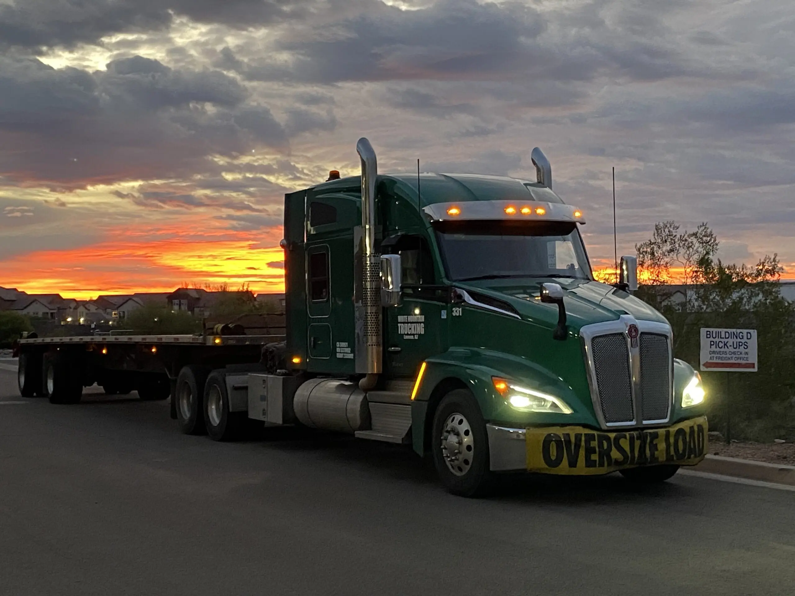 White Mountain Trucking heavy-haul truck transporting construction equipment